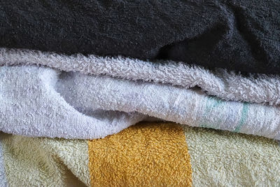 Close up view on samples of cloth and fabrics in different colors found at a fabrics market.