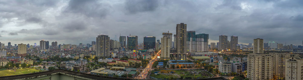 Panoramic view of buildings in city against sky