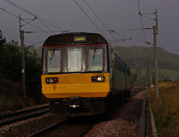 Train on railroad tracks against clear sky