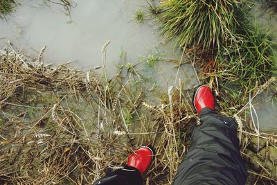 Low section of person wearing rubber boots