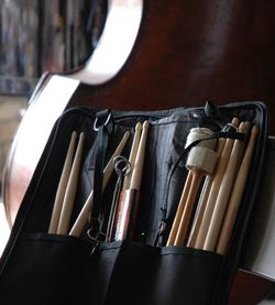 Close-up of drumsticks in bag