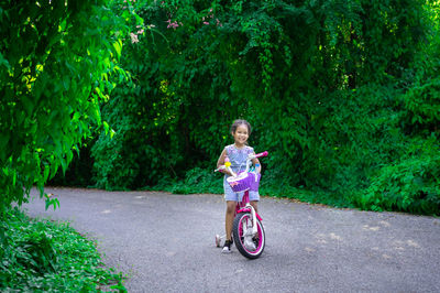 Boy riding bicycle on road