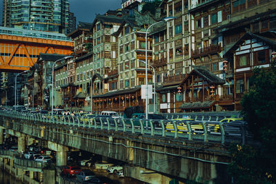 Train on bridge against buildings in city