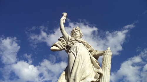 Low angle view of statue against blue sky