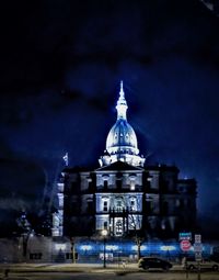 Illuminated building against sky at night