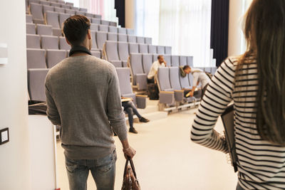 Young students entering lecture hall in university