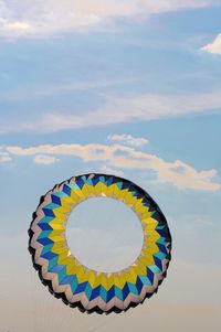 Low angle view of colorful kite flying in sky