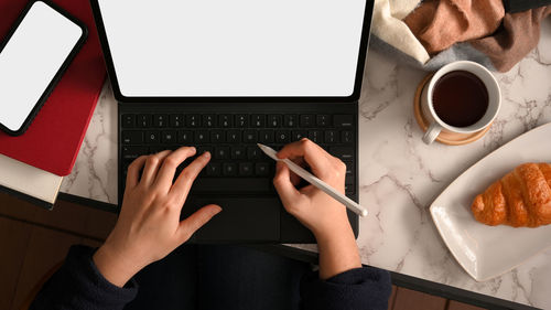 Midsection of woman using laptop