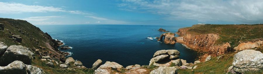 Scenic view of rocky beach against sky