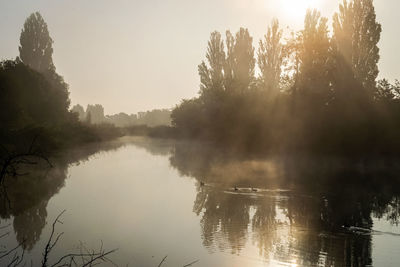 Scenic view of lake against sky at morning