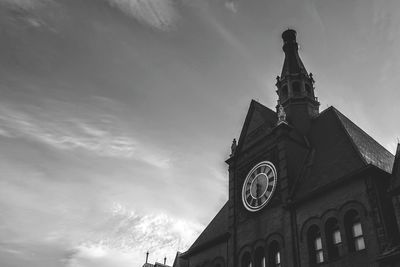 Low angle view of clock tower against sky