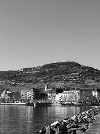 River by townscape against clear sky