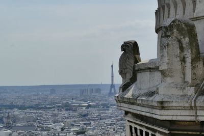 Statue in city against sky in paris