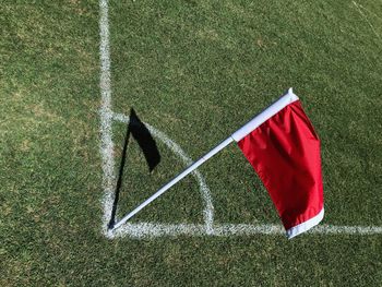 High angle view of red flag on soccer field during sunny day