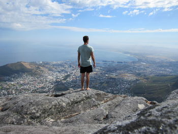 Rear view of man standing on mountain