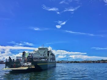 Ship in sea against sky in city