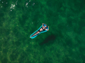 High angle view of woman floating on water