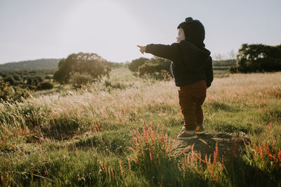 Full length of man standing on field against sky