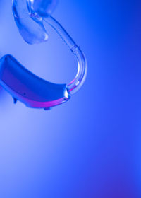 High angle view of illuminated lighting equipment against blue background