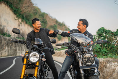 Man riding motorcycle on road