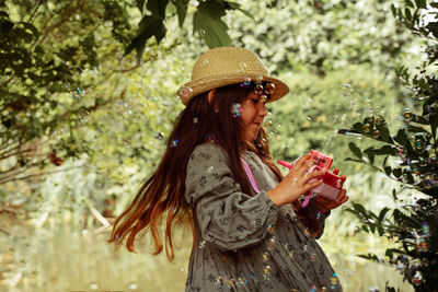 Girl playing with bubbles outdoors