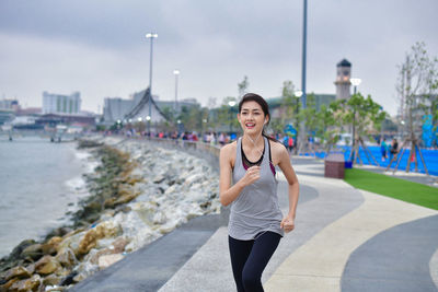 Portrait of smiling young woman in city