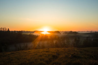 The summer sun rising over a rural scenery. sunrise landscape. summertime scenery of northern europe