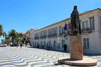 Buildings in town against clear blue sky