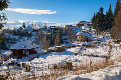 Scenic wintry view of the village of harghita bai, romania