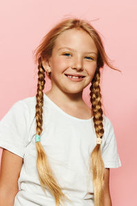 Portrait of young woman against white background