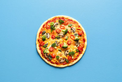 Directly above shot of pizza against blue background