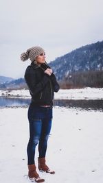 Full length of senior woman standing on snow covered land