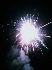 Low angle view of firework display at night