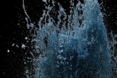 Close-up of water splashing against black background