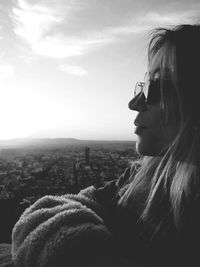 Portrait of woman looking away against sky