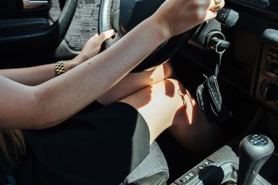 Cropped image of woman sitting in car