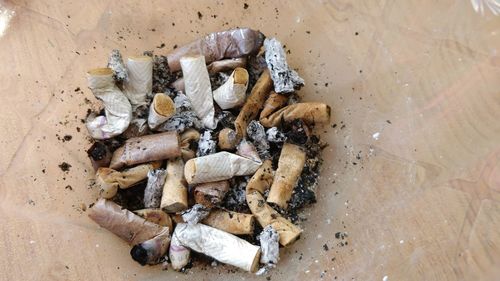 High angle view of cigarette on floor