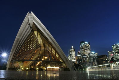 Low angle view of city lit up at night