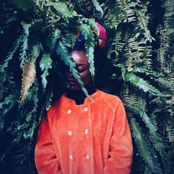 Woman standing amidst leaves