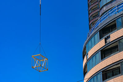 Low angle view of modern building against clear blue sky