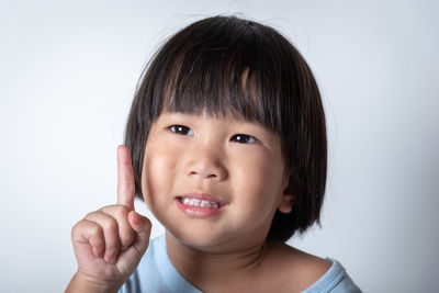 Portrait of cute baby against white background