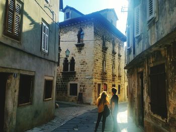 Couple standing amidst buildings in vodnjan