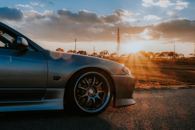 View of car on road against cloudy sky