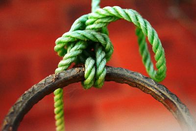 Close-up of rope tied up on metal ring