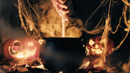 Pot with magic smoke coming out and halloween pumpkins