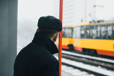 Rear view of man at railroad station