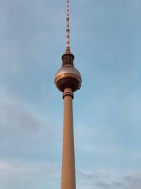 Low angle view of communications tower against sky