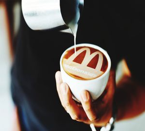 Close-up of hand holding coffee cup