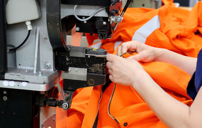 Close-up of woman using sewing machine