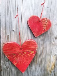 Close-up of wooden heart shape hanging on wall